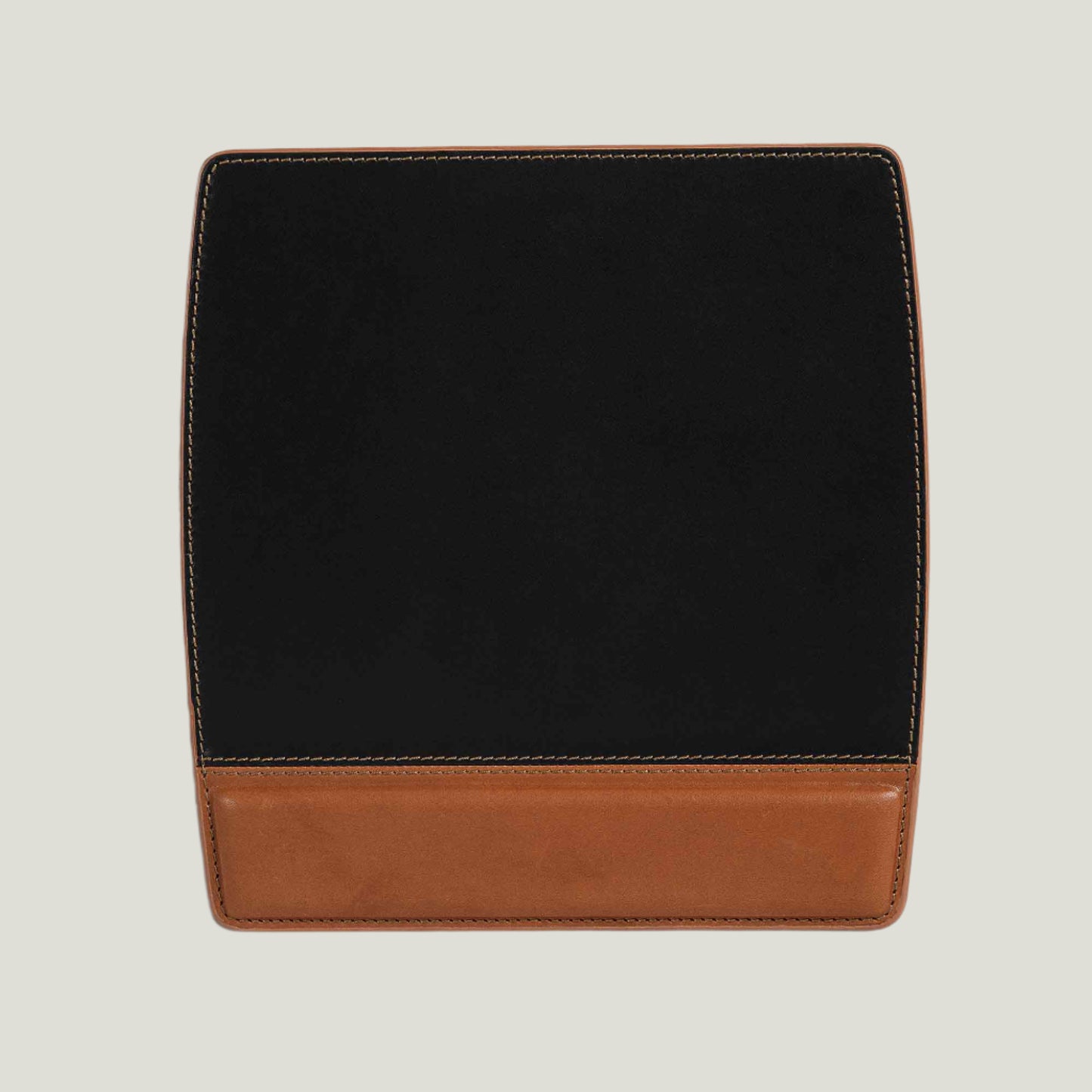 A handcrafted Bumpy Leather Mouse Pad in Maui Charcoal Black, made from full-grain leather with a suede-backed grip, offering firm support and personalization.
