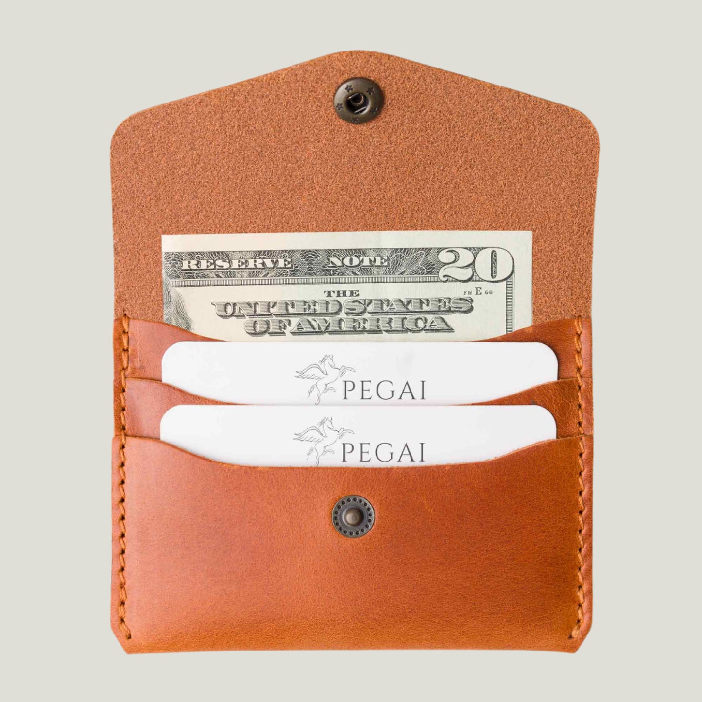 Handcrafted Whiskey brown leather card holder with a slim design, holding up to 6 cards and 2 bills. Features fire-branded initials for a personalized touch.