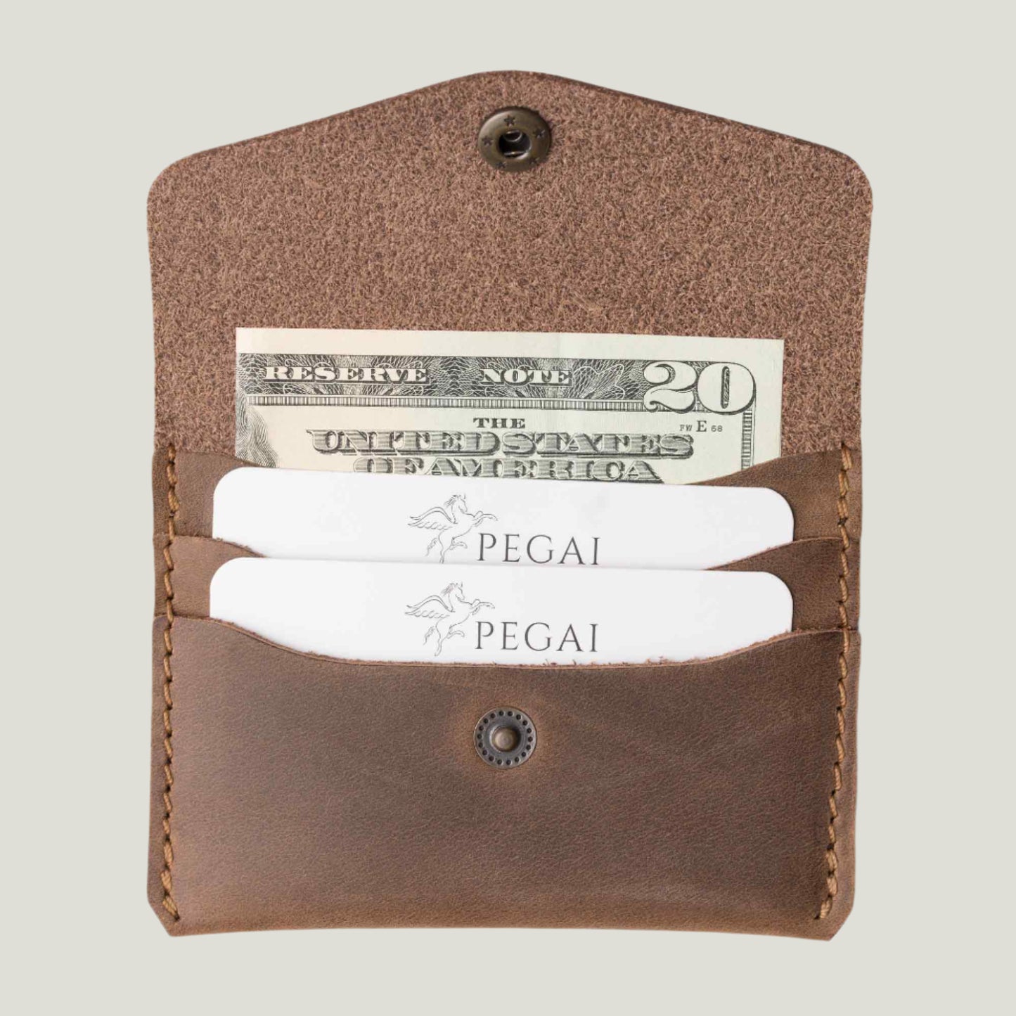 Handmade sand brown-colored leather card holder, slim and elegant, holding six cards and two folded bills. Personalizable with initials for a unique touch.
