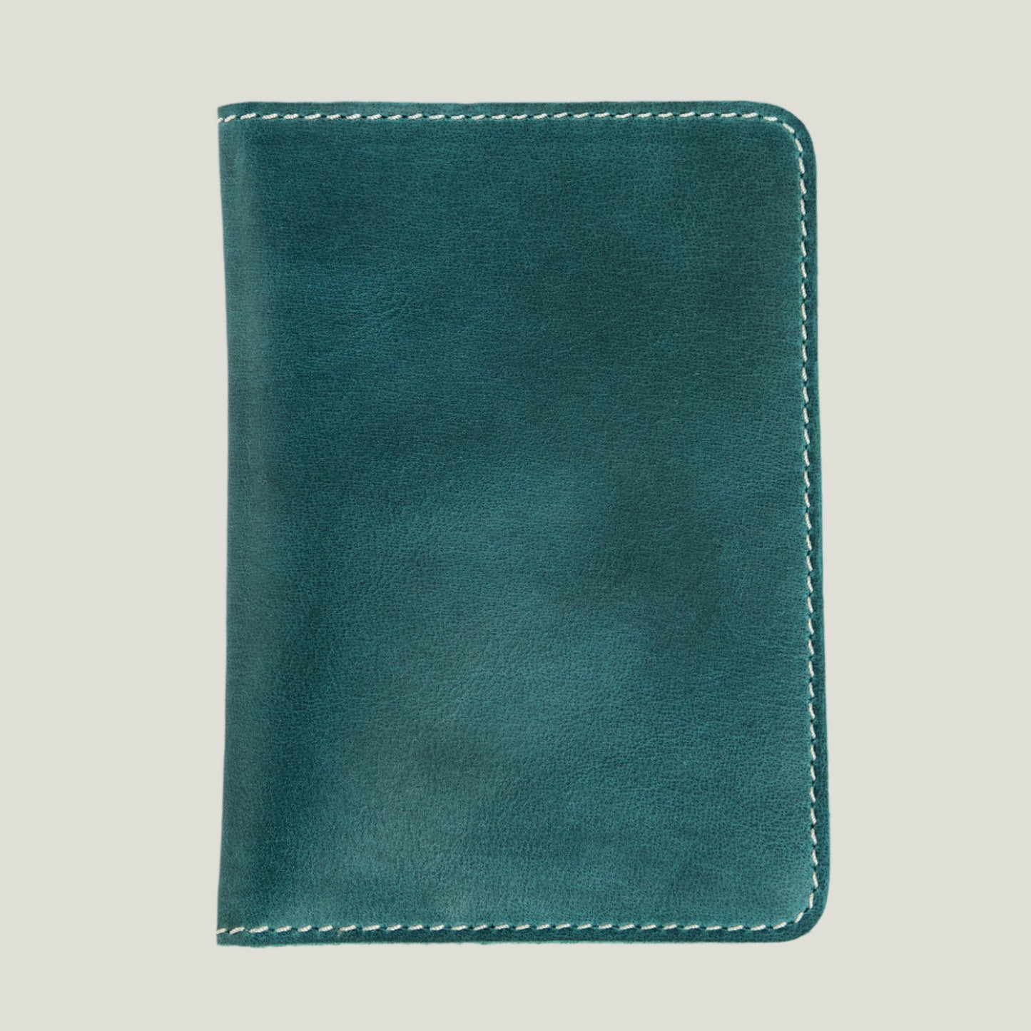 Turquoise leather passport wallet by Atelier PEGAI, handcrafted with card slots and a hidden pocket. Personalizable with fire-branded initials for a unique touch.