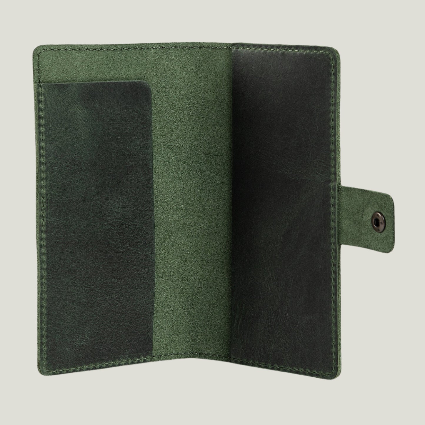Green leather checkbook cover with antique brass snap closure, handcrafted in Spain by Atelier PEGAI. Personalizable with fire-branded initials for a unique touch.