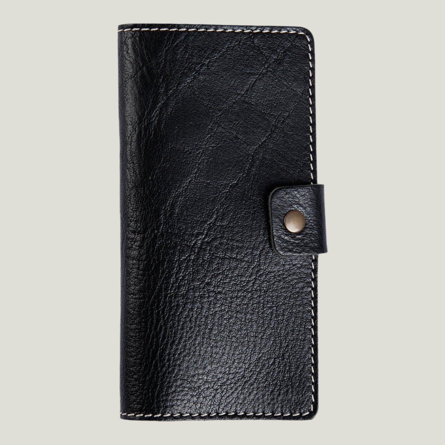 Phokion Black Clark Leather Checkbook Cover with antique brass snap, extra pocket, and personalized fire-branded initials, handcrafted in Ubrique by Tanner Leatherstein.