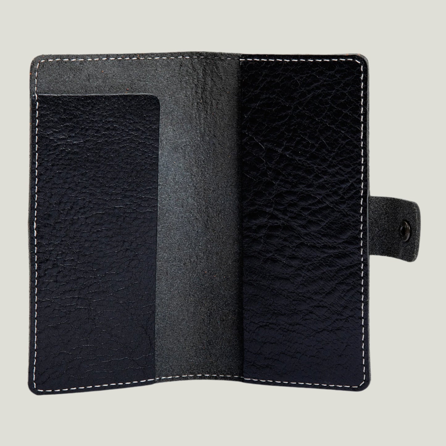 Phokion Black Clark Leather Checkbook Cover with antique brass snap, extra pocket, and personalized fire-branded initials, handcrafted in Ubrique by Tanner Leatherstein.