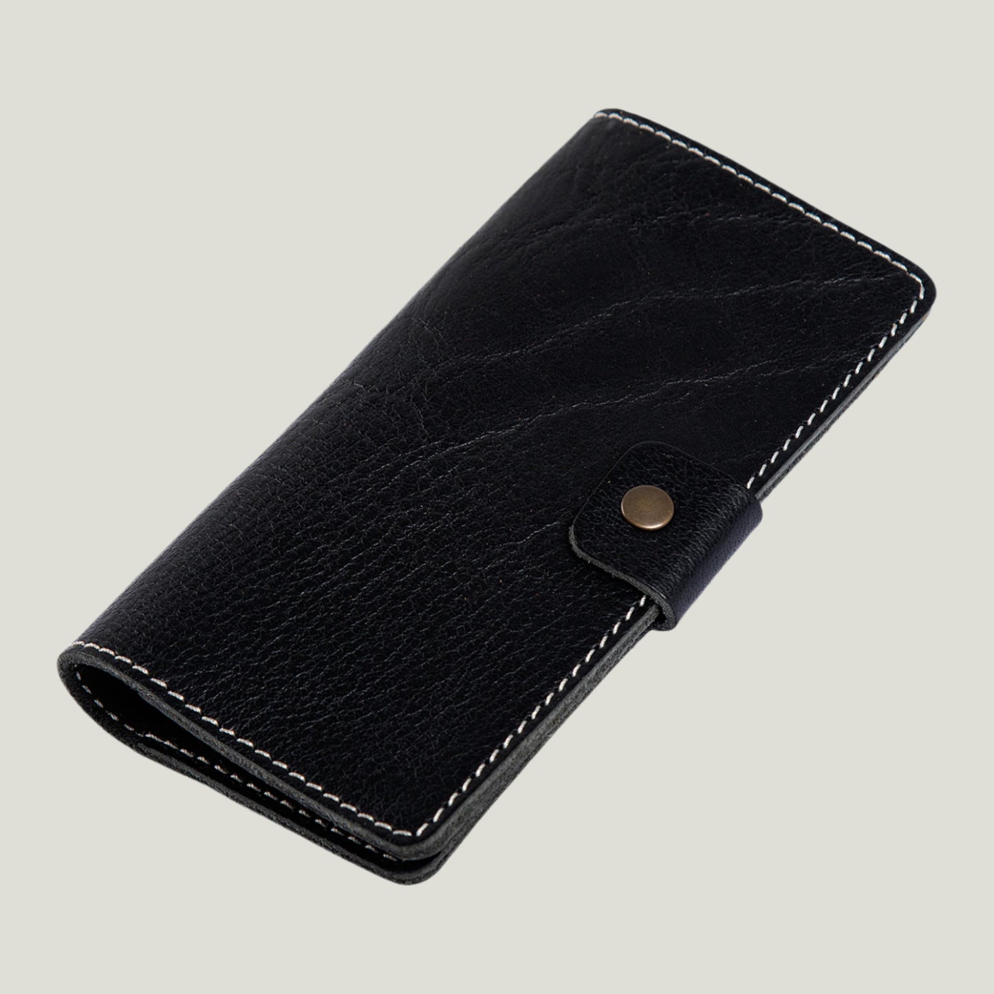 Phokion Black Clark Leather Checkbook Cover with antique brass snap, extra pocket, and personalized fire-branded initials, handcrafted in Ubrique by Tanner Leatherstein.