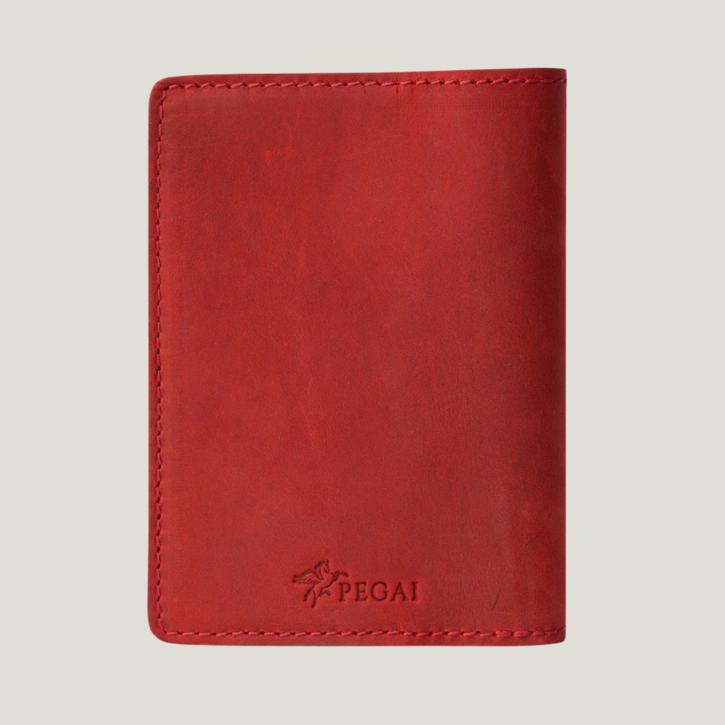 Close-up of the DeKalb Leather Passport Cover in Rose, handcrafted from top-grain leather with a timeless design. Features fire-branded initials for personalization.
