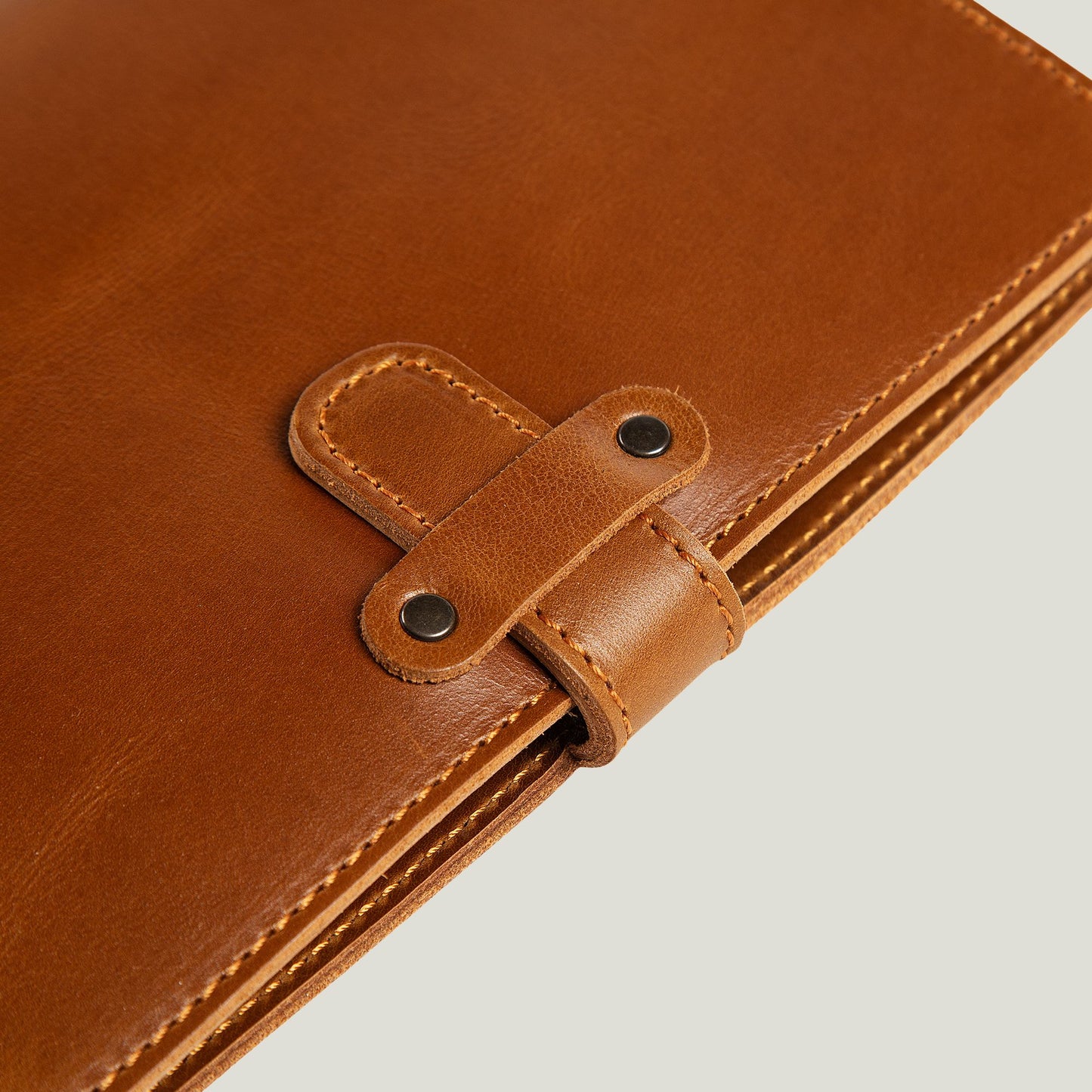 Handcrafted mustard leather journal with antique brass hardware, refillable pages, and personalized initials—designed to age beautifully over time.