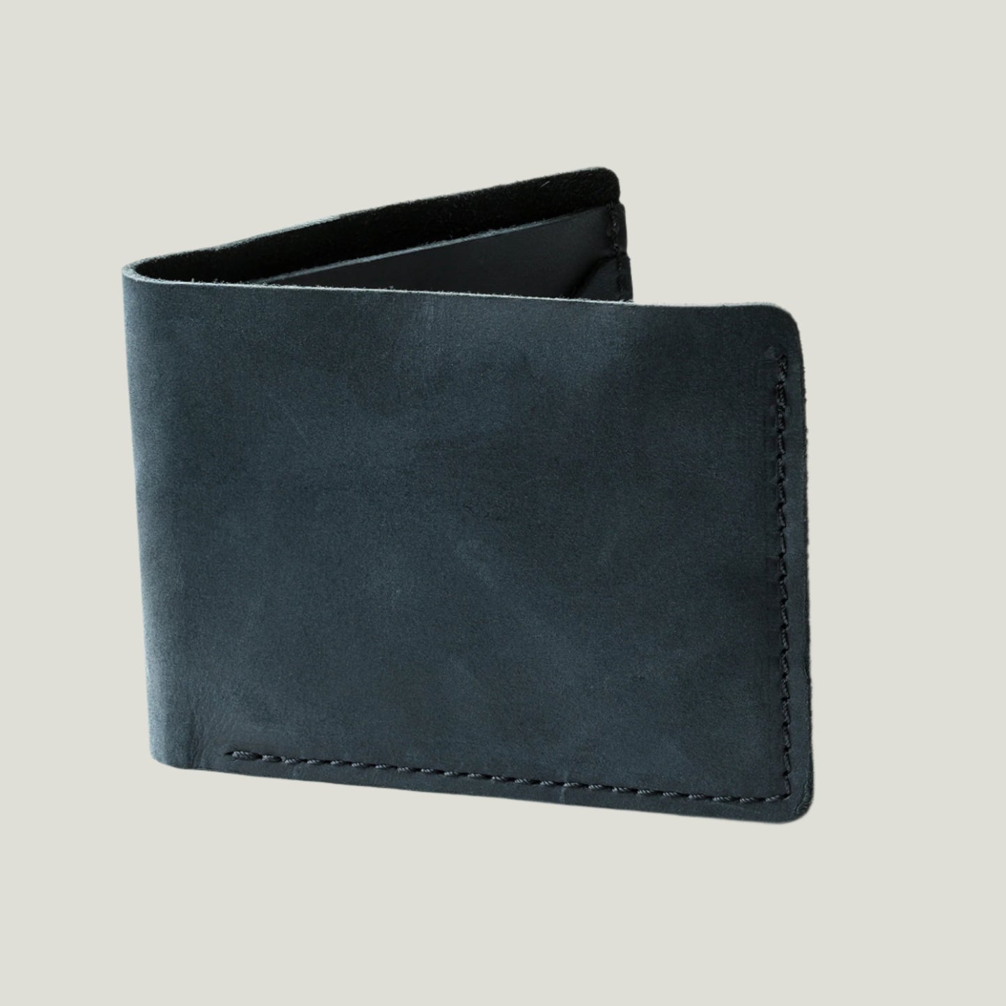 Charcoal leather bifold wallet handcrafted in Spain, featuring four card slots, a bill compartment, and fire-branded initials for a personalized touch.