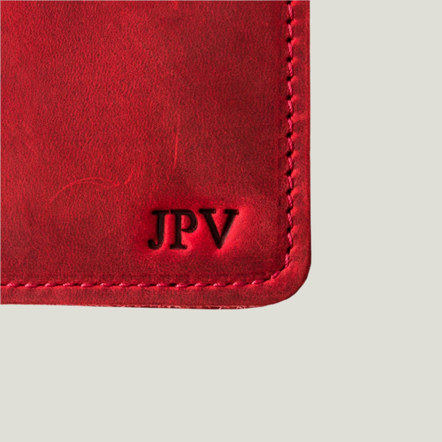 Close-up of the Pike Leather Passport Wallet in Rose, handcrafted by Atelier PEGAI, showcasing high-quality leather, card slots, and fire-branded personalization.