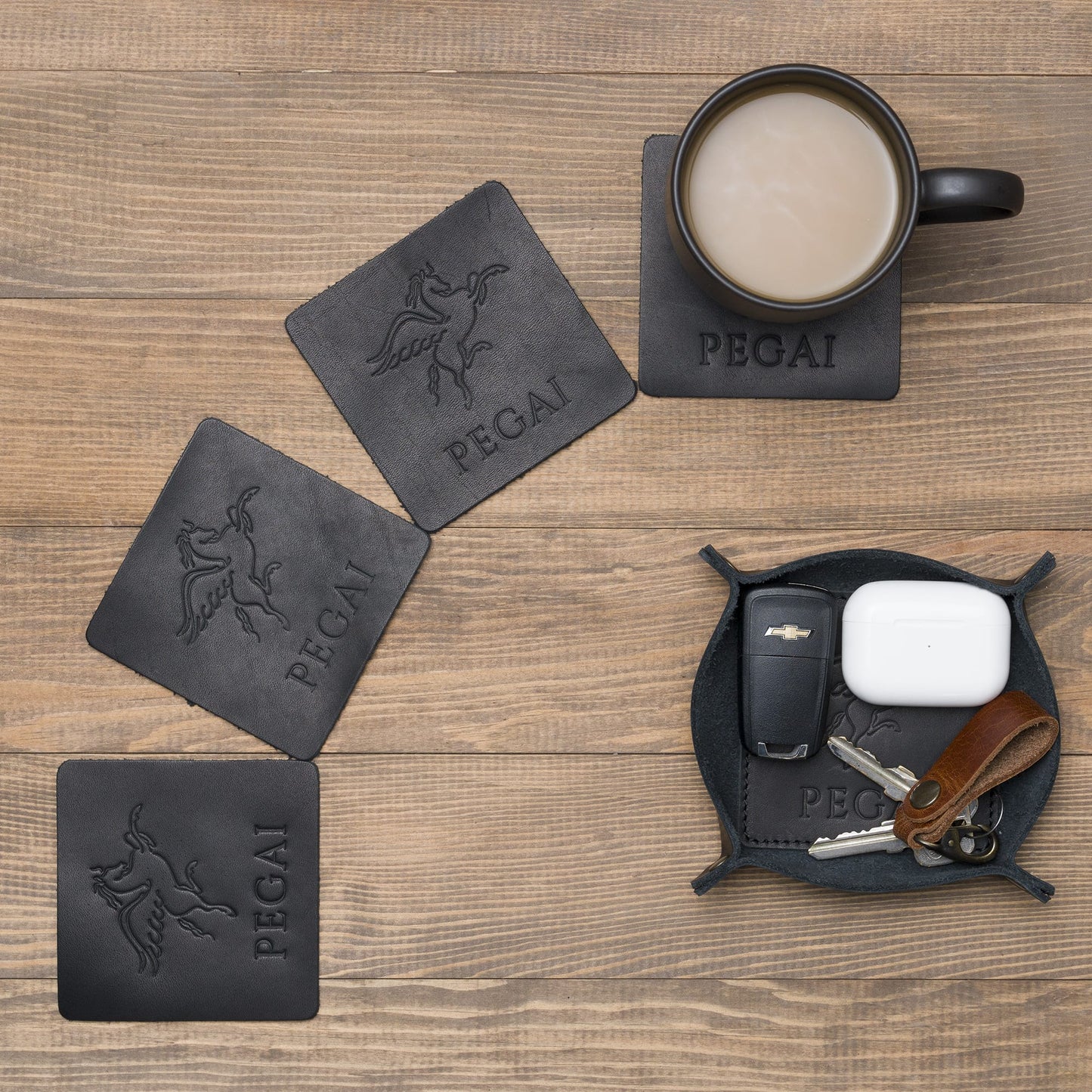 Black leather coasters and catchall tray set, handcrafted in Spain. Elegant, durable, and designed with expert craftsmanship inspired by Tanner Leatherstein.