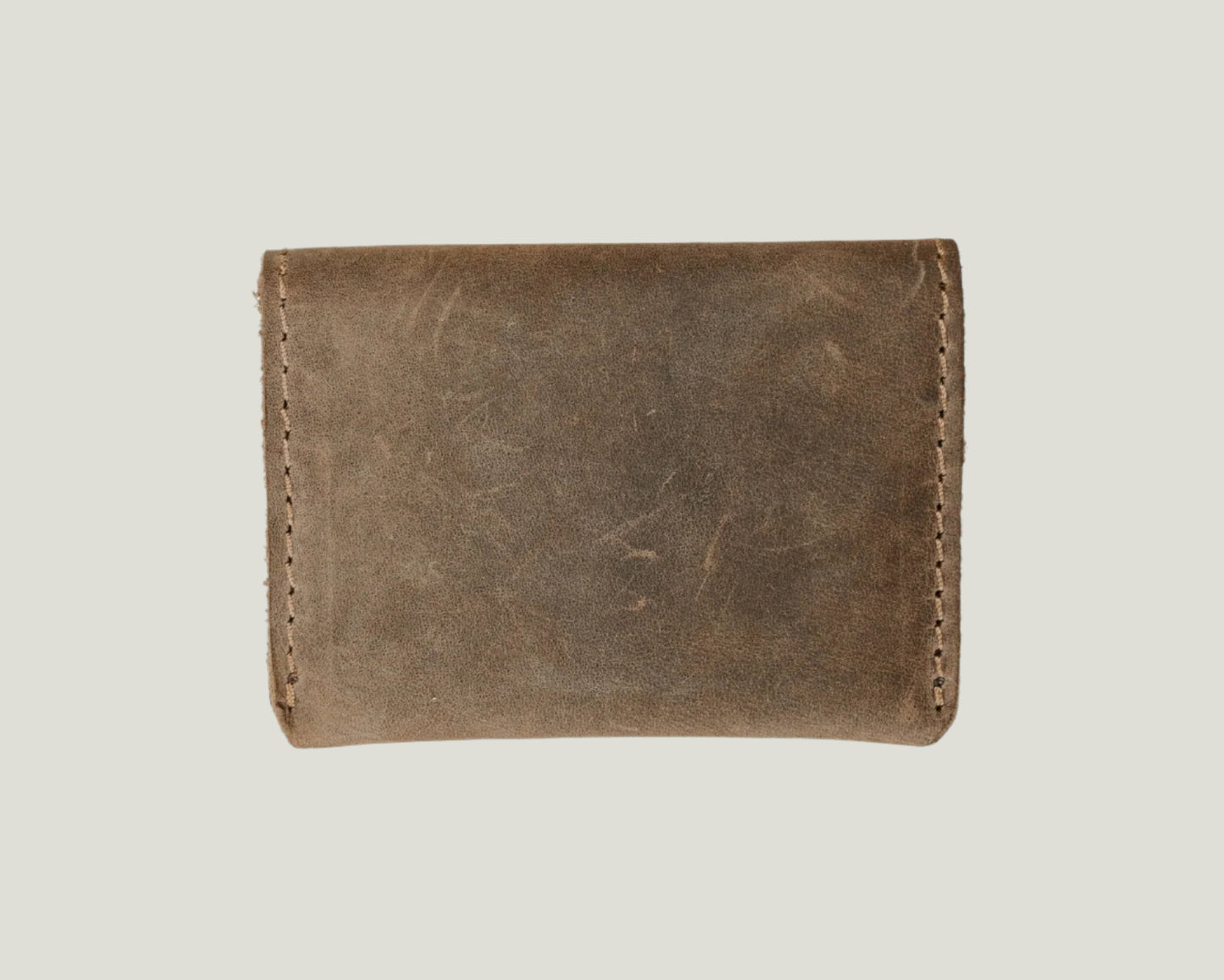 Close-up of the Champaign Leather Wallet in Sand, showcasing its sleek bifold design, top-grain leather texture, card slots, hidden pockets, and personalized initials.