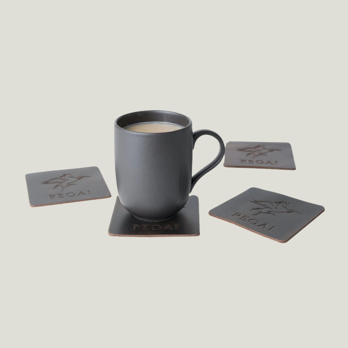 Antique brown leather coaster set by Atelier PEGAI, crafted in Ubrique, Spain, showcasing timeless craftsmanship and expert design by Tanner Leatherstein.