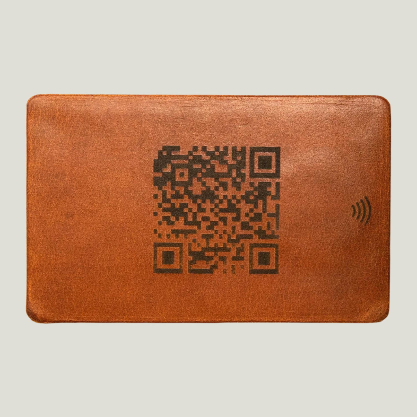 Whiskey Brown leather NFC business card with personalized engraving, crafted by Atelier PEGAI for seamless digital networking and a lasting first impression.