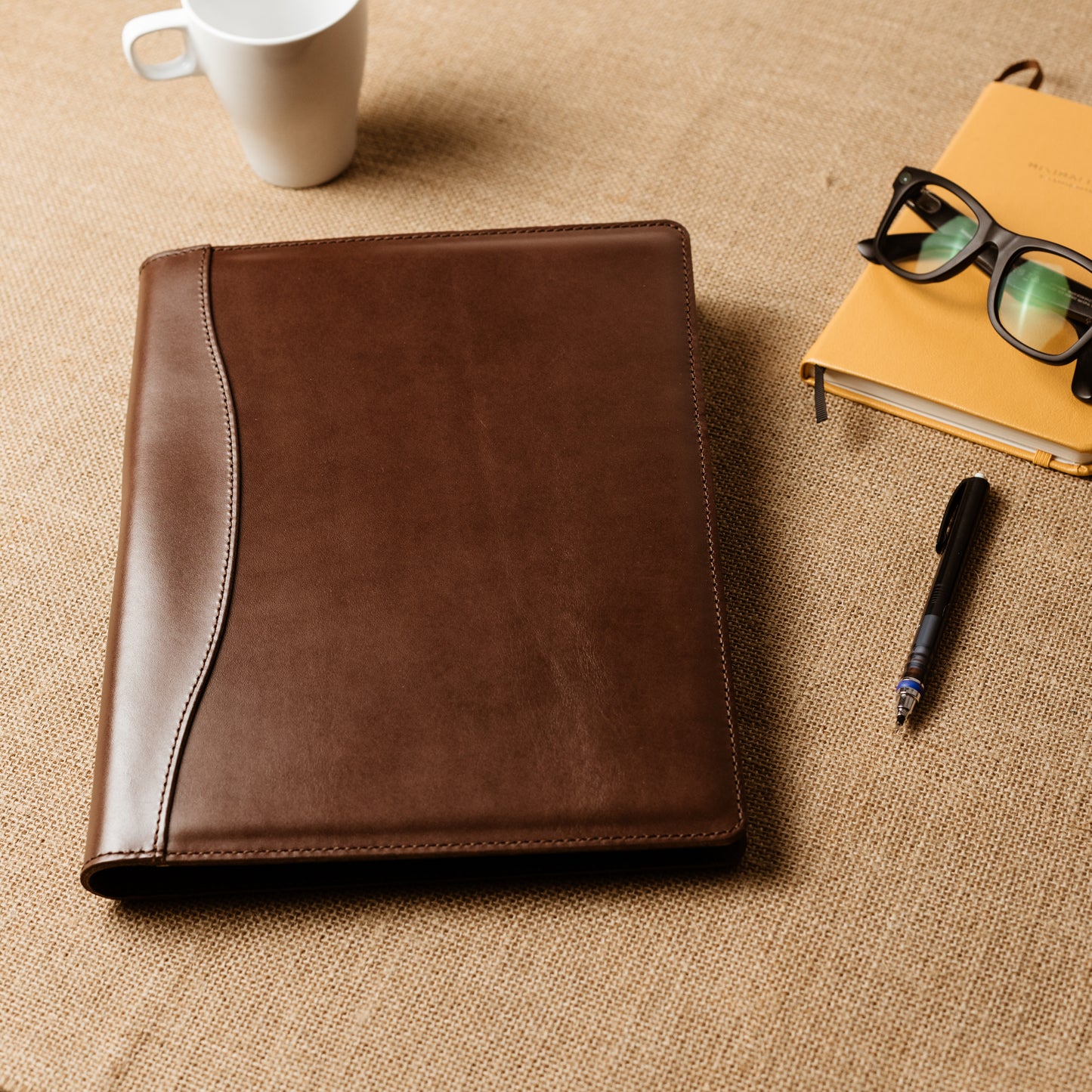 Slim leather padfolio in Barkley Brown with pen holder, business card pocket, and A4 folder—crafted by Tanner Leatherstein for legal pads.