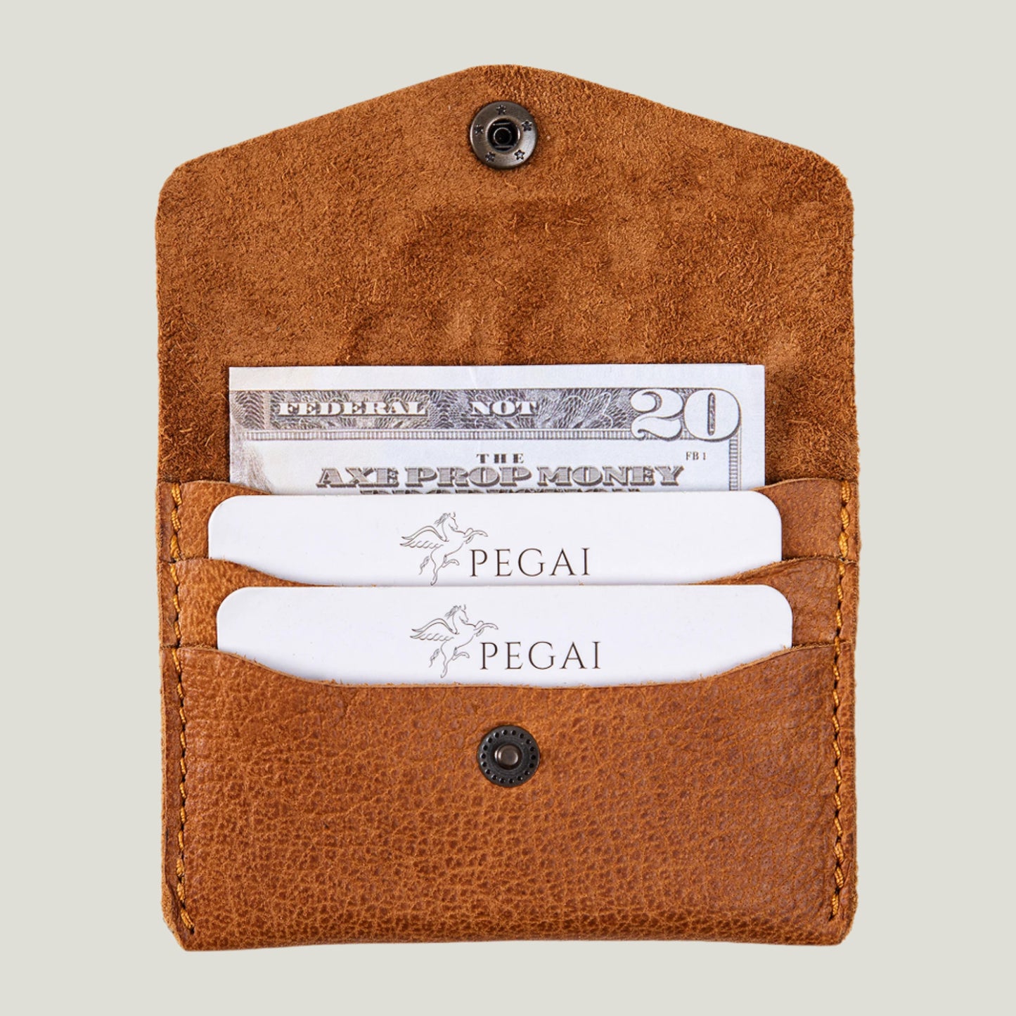 Close-up of the Seline Leather Card Holder in Aniketos Cinnamon, handcrafted from top-grain leather. The slim, elegant design holds up to six cards and two folded bills, fitting effortlessly into any bag. Personalized initials add a unique touch, making it a timeless, functional accessory.