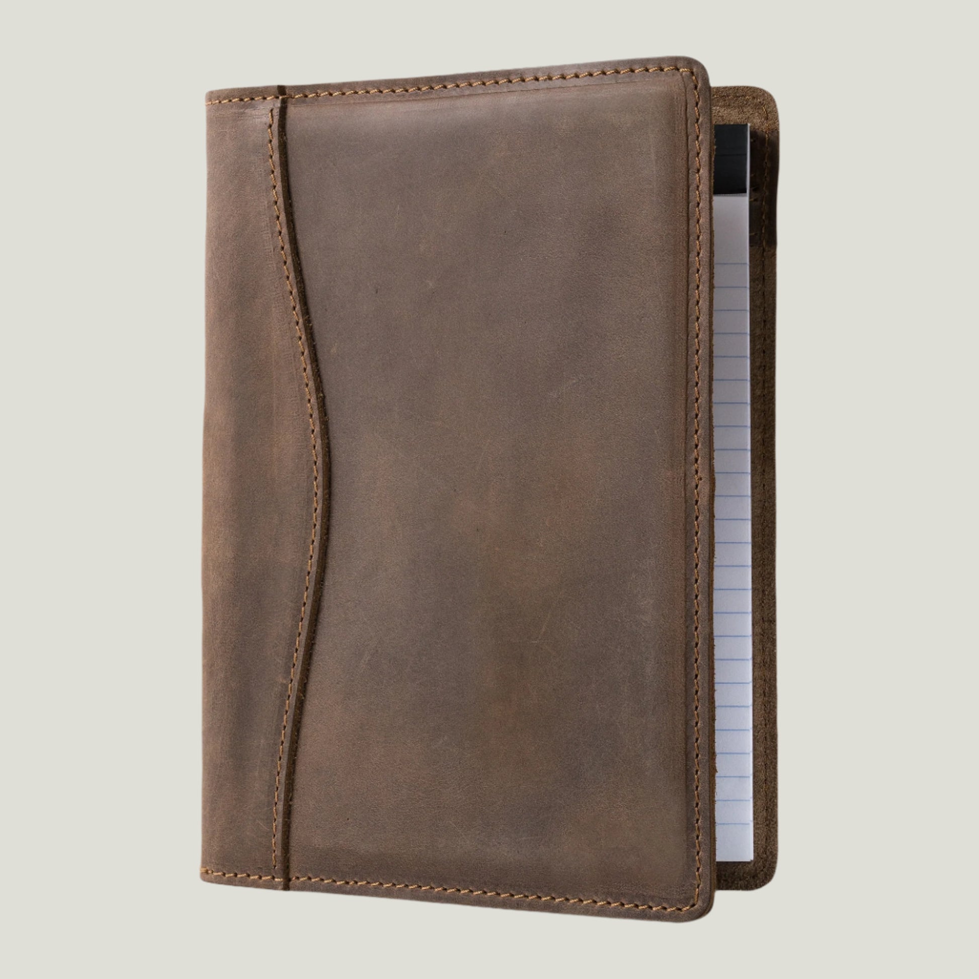 Elegant sand-colored leather padfolio with a pen holder, business card slot, and inside pocket, crafted by Atelier PEGAI. Designed for 8” x 5” legal pads, this handcrafted piece blends rustic charm with personalization, featuring fire-branded initials for a timeless, bespoke touch.