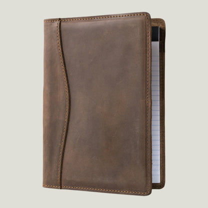 Elegant sand-colored leather padfolio with a pen holder, business card slot, and inside pocket, crafted by Atelier PEGAI. Designed for 8” x 5” legal pads, this handcrafted piece blends rustic charm with personalization, featuring fire-branded initials for a timeless, bespoke touch.