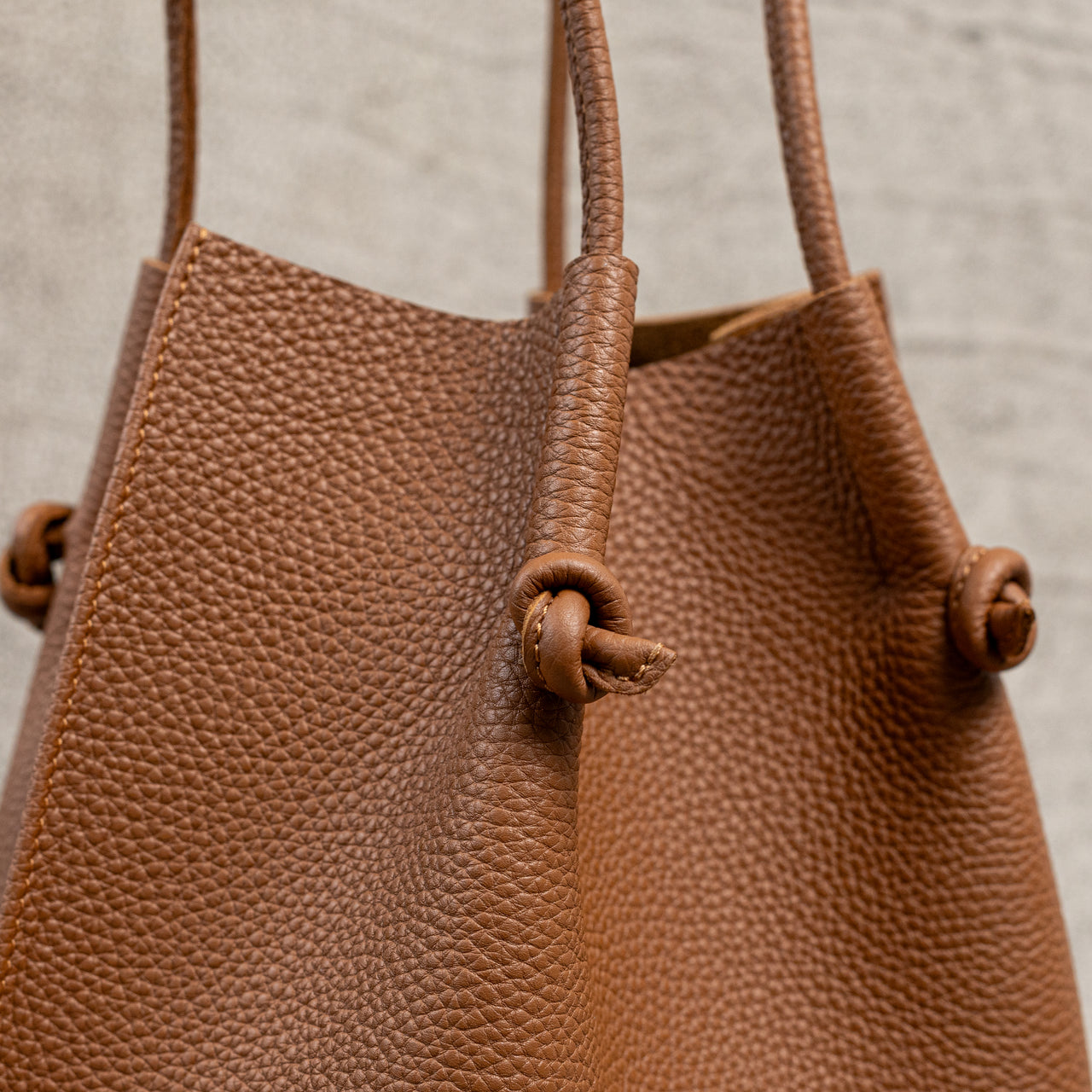 Flora Everyday Leather Tote in Togo Calf Taba with suede interior, rolled handles, and hand-finished edges—crafted for everyday function and rustic charm.