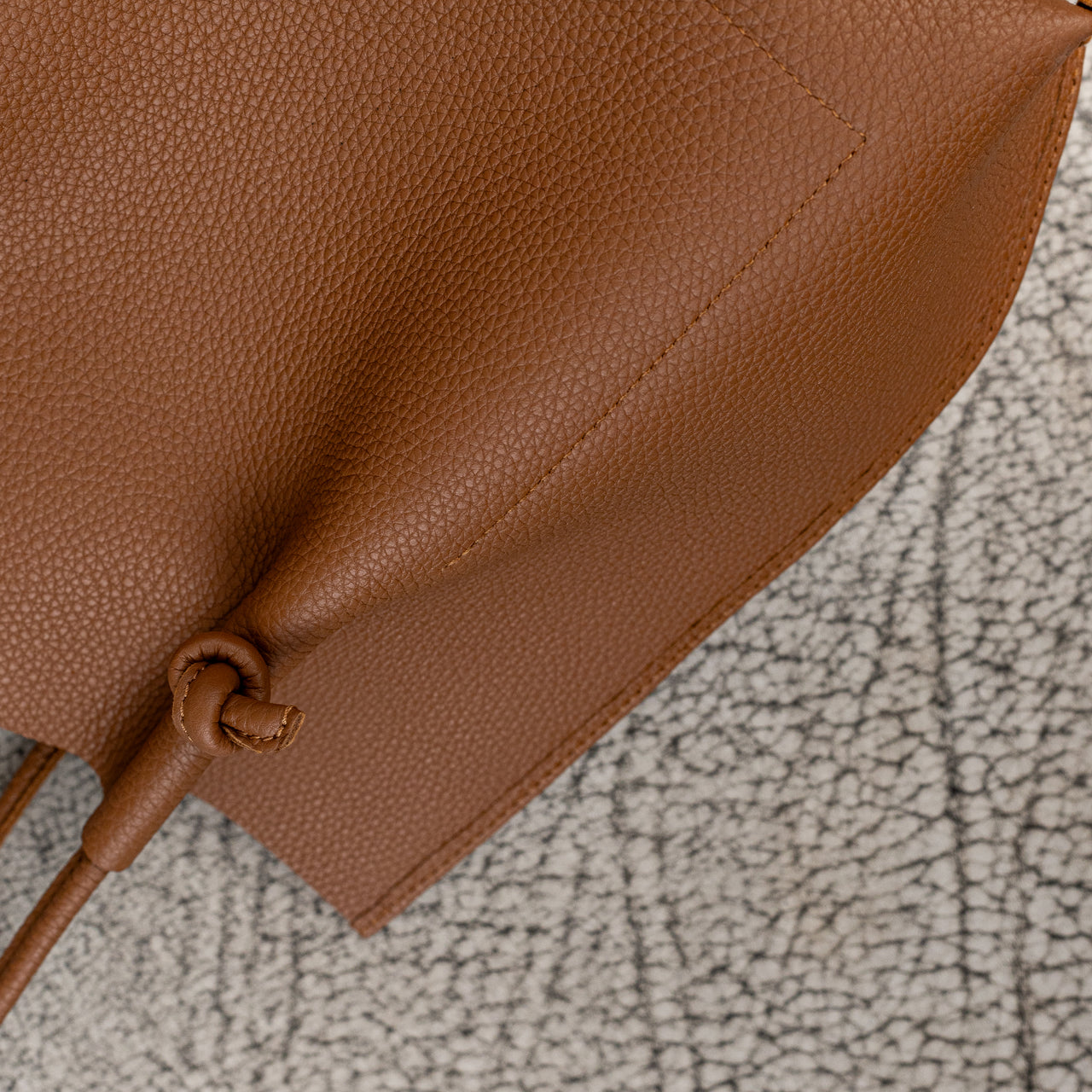 Flora Everyday Leather Tote in Togo Calf Taba with suede interior, rolled handles, and hand-finished edges—crafted for everyday function and rustic charm.