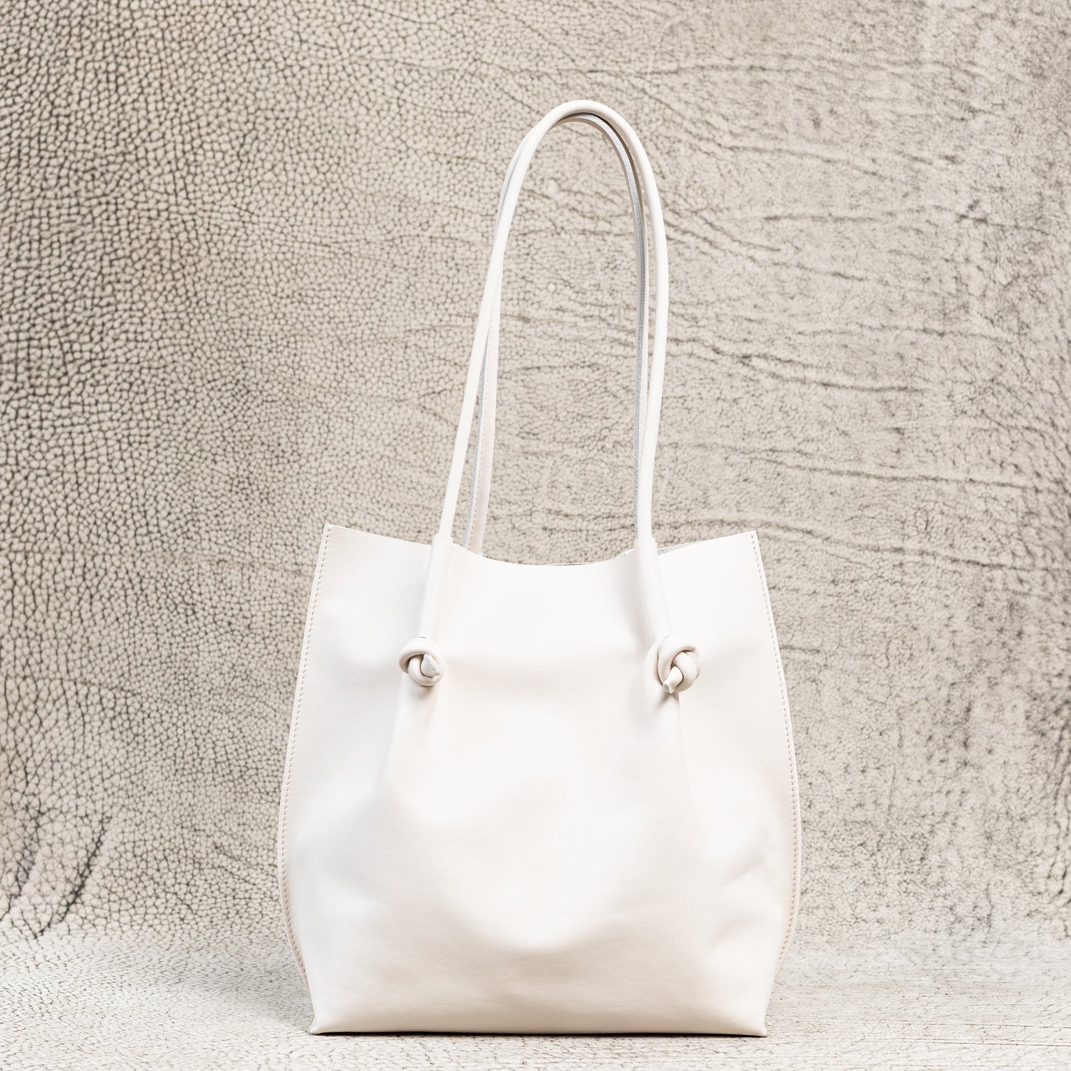 Flora Everyday Leather Tote in Smooth Calf Cream with suede interior, rolled handles, and artisan edge finishes—crafted for beauty in the everyday.