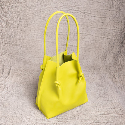 Angled view of the Flora Leather Tote highlighting its spacious open-top and raw suede interior in vibrant lime leather.