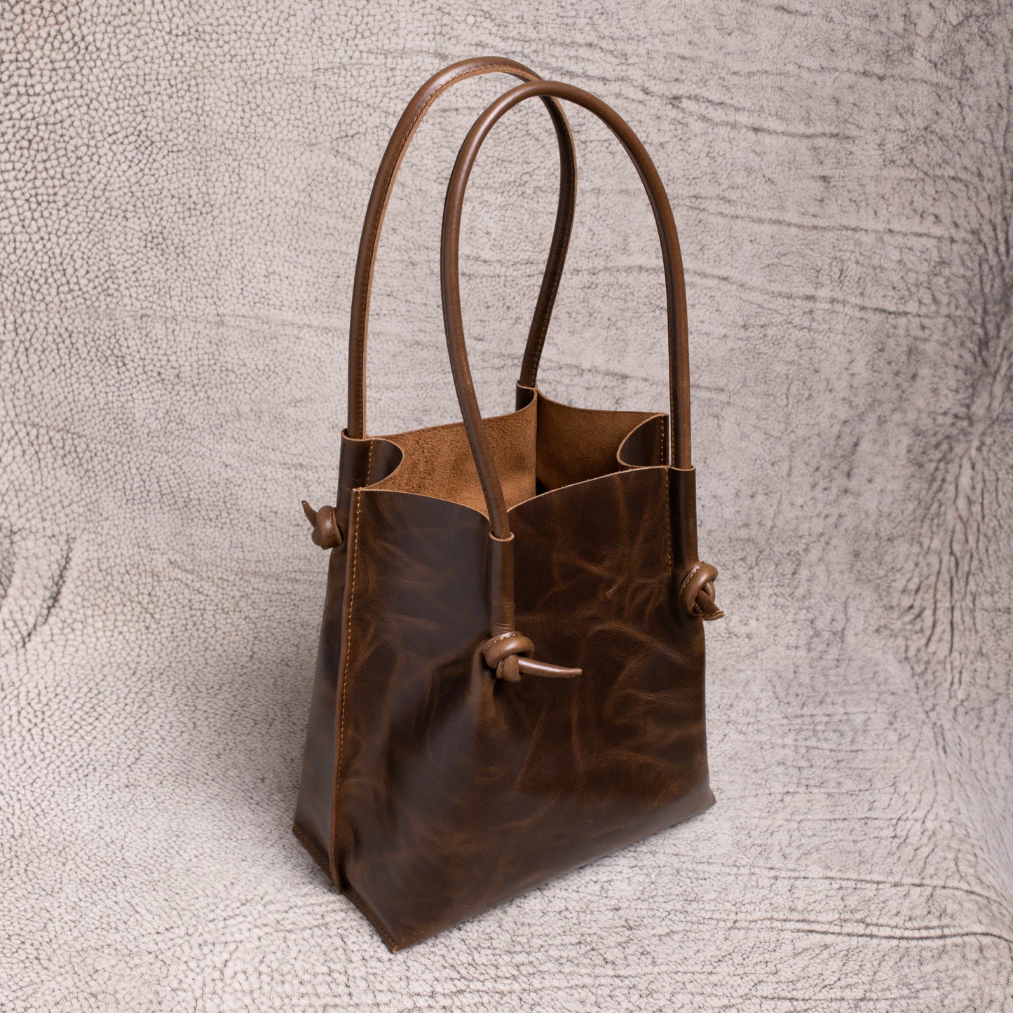 Angled view of the Flora Leather Tote revealing its spacious open-top interior and minimalist design made for everyday elegance.