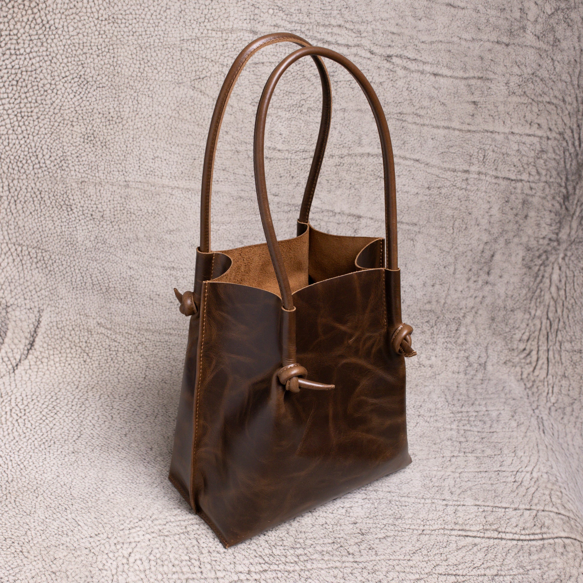 Angled view of the Flora Leather Tote revealing its spacious open-top interior and minimalist design made for everyday elegance.