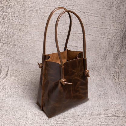 Angled view of the Flora Leather Tote revealing its spacious open-top interior and minimalist design made for everyday elegance.