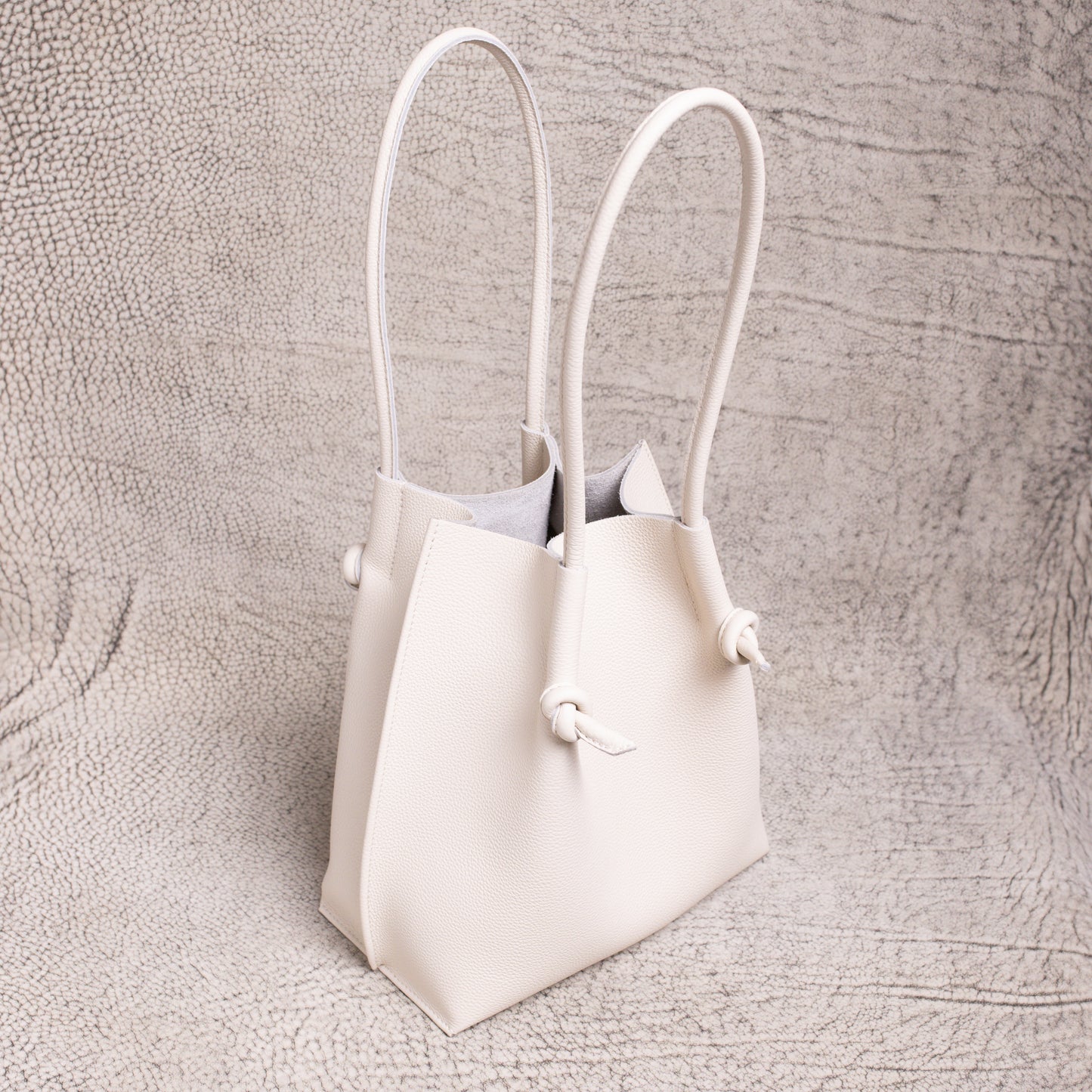 Three-quarter angle of the Beige Flora Tote highlighting its structure and long handles.