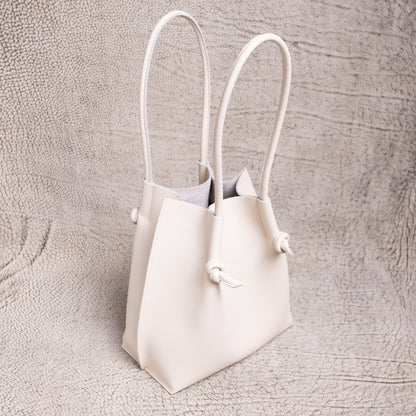 Three-quarter angle of the Beige Flora Tote highlighting its structure and long handles.