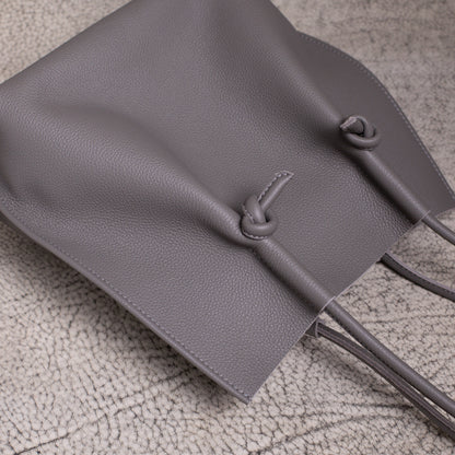Flat lay from above showing the relaxed shape of the Flora tote, with the handles and knotted design resting naturally.