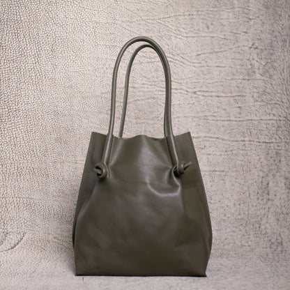 Front view of the Flora Leather Tote in Smooth Calf Green, featuring minimalist knotted handles and clean, structured artisan leather.