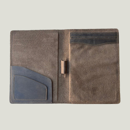 Open chestnut brown leather padfolio showing interior pockets, pen loop, and suede lining—perfect for work or gifting.