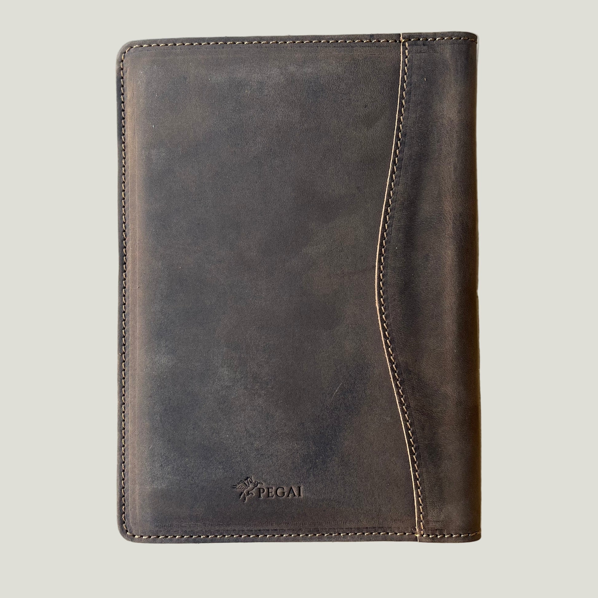 Closed leather padfolio in rugged chestnut finish with PEGAI logo—ideal for daily carry, journaling, or gifting.
