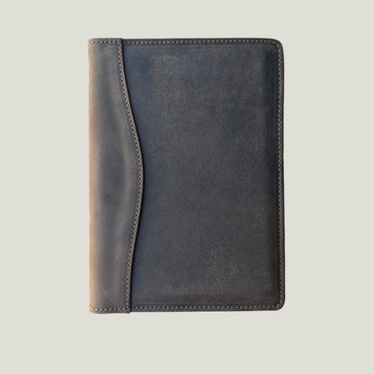 Minimalist top-down view of closed padfolio in full-grain chestnut leather—stylish gift for him or her.