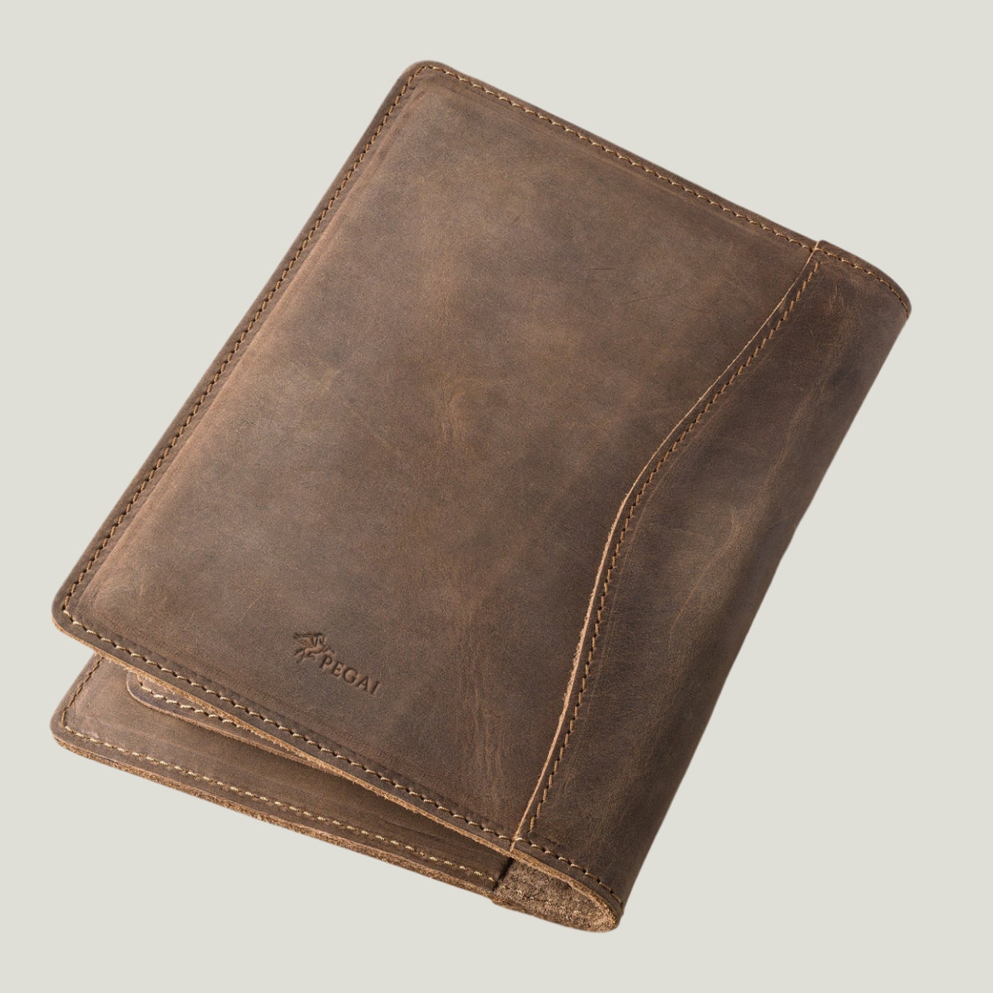Elegant sand-colored leather padfolio with a pen holder, business card slot, and inside pocket, crafted by Atelier PEGAI. Designed for 8” x 5” legal pads, this handcrafted piece blends rustic charm with personalization, featuring fire-branded initials for a timeless, bespoke touch.