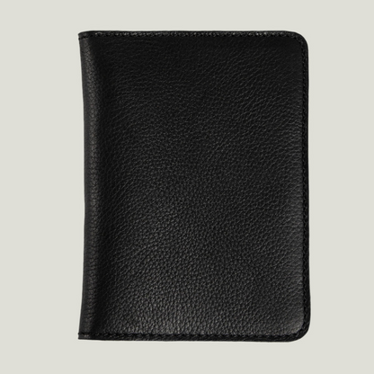Front view of a black leather passport holder on a light background.