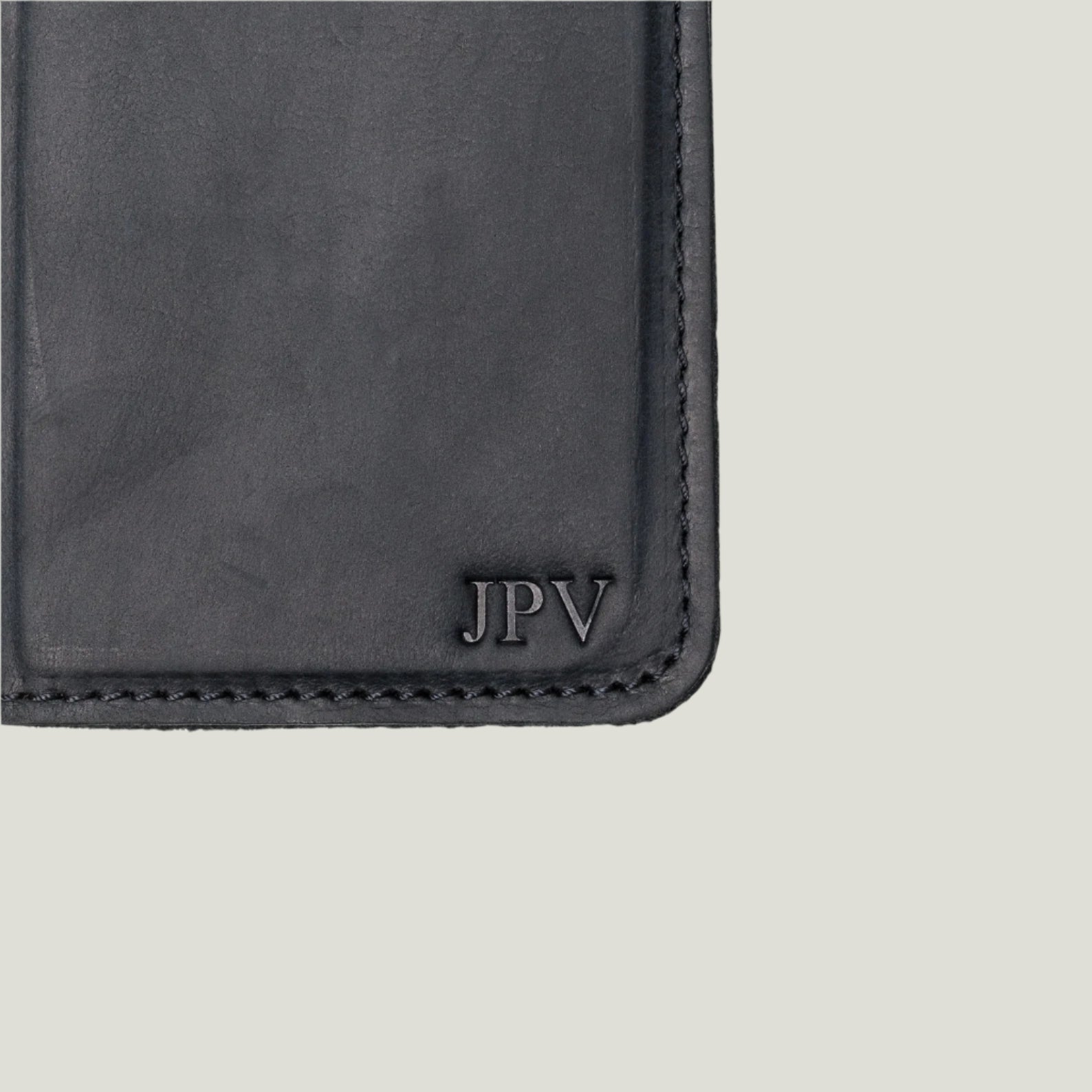 McLean wallet propped open with a phone in the case, capturing the seamless integration of phone and wallet functionalities.