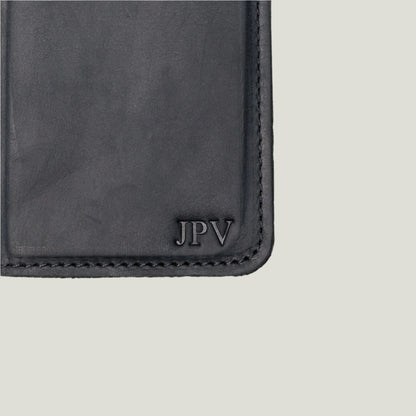 McLean wallet propped open with a phone in the case, capturing the seamless integration of phone and wallet functionalities.