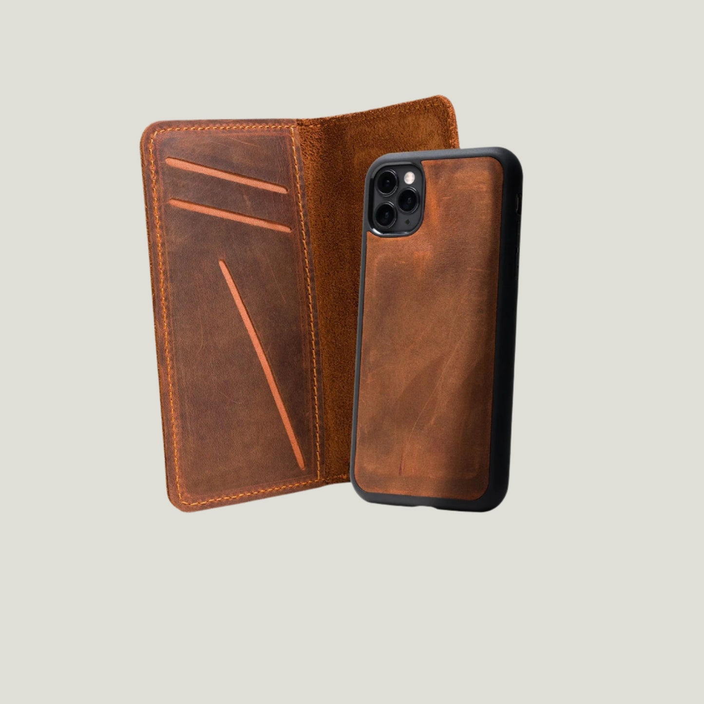 Open view of warm mahogany brown leather iPhone wallet case with three angled card slots and detachable phone cover.