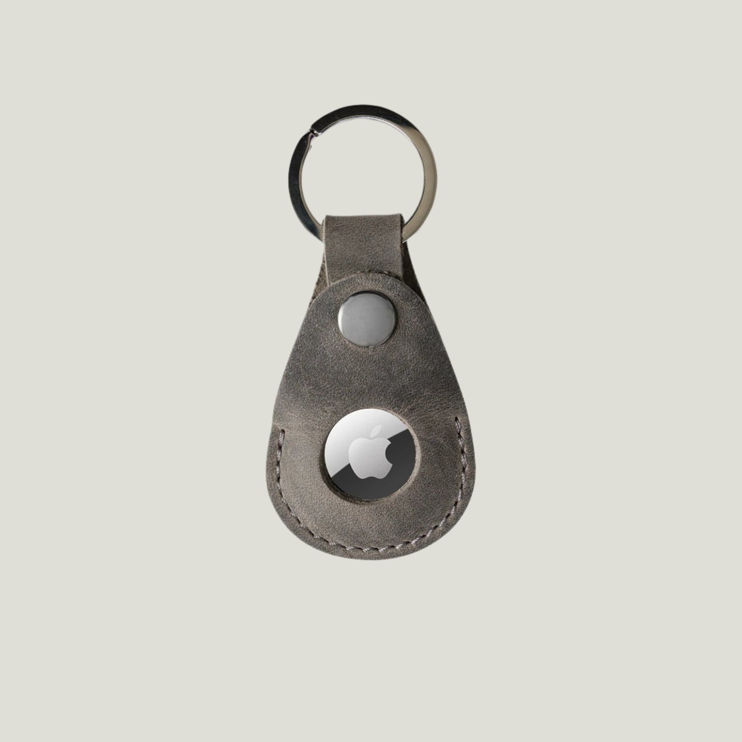 Close-up of the Pear Leather AirTag Holder in Rock, showcasing premium craftsmanship, durable nickel hardware, and a sleek design by Atelier PEGAI.