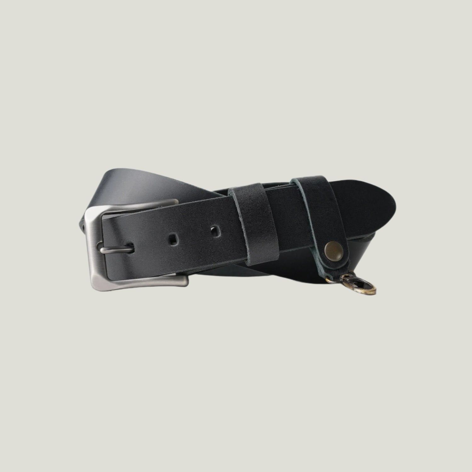 Black McKinney Leather Belt with brushed nickel buckle and matching keyloop, handcrafted in Spain. Personalizable with fire-branded initials for a unique touch.