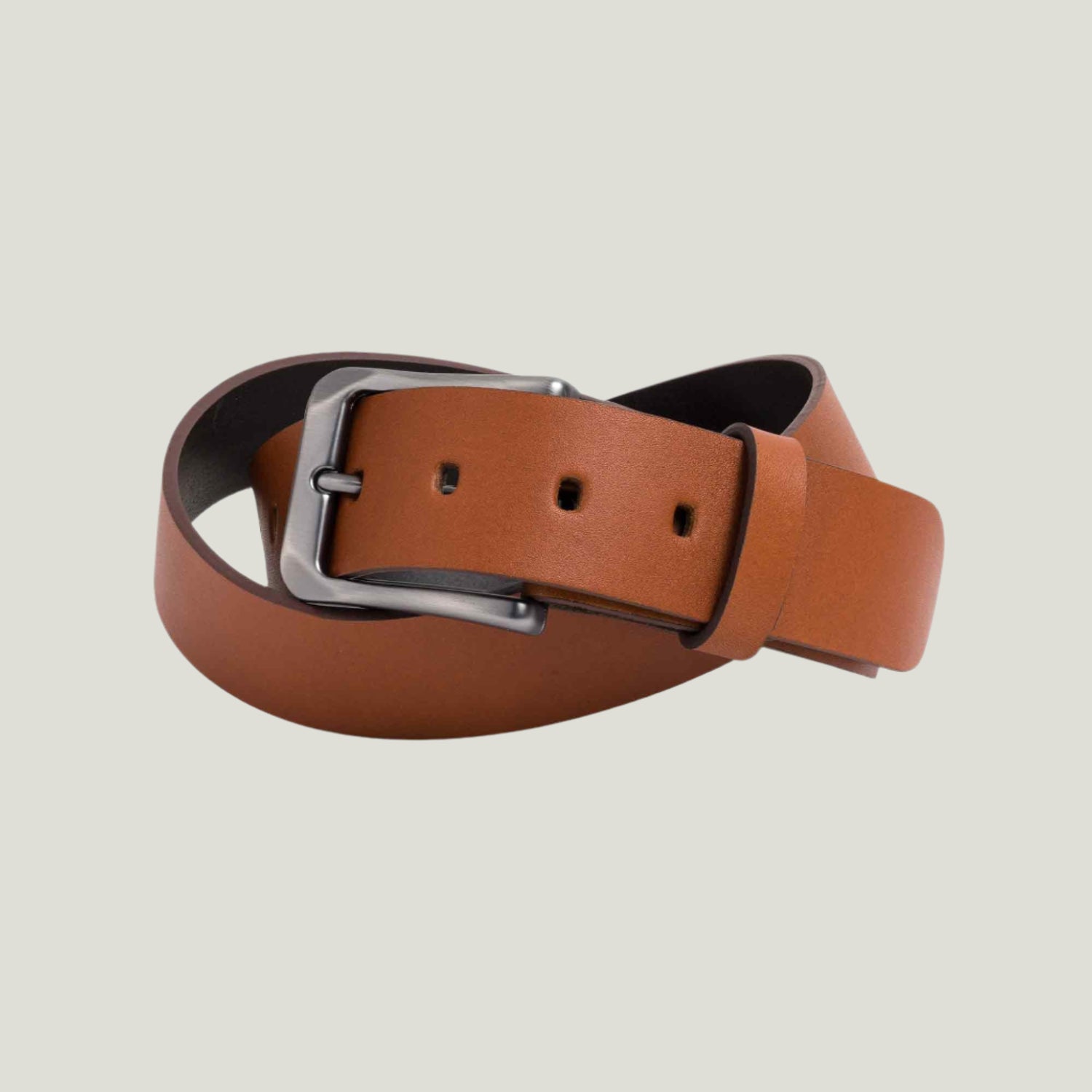 Cognac leather belt with brushed nickel buckle, handcrafted by Atelier PEGAI. Features seven holes and customizable fire-branded initials for a personal touch.